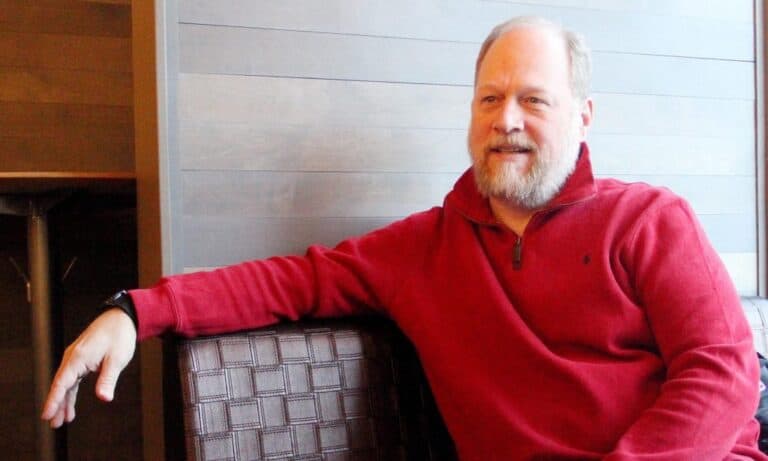 Friendly man relaxing in modern office environment, representing professional IT services and technology support by Twin State Technical Services.