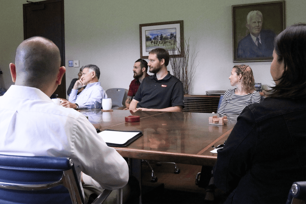 Professional business meeting with diverse team discussing strategies in conference room.