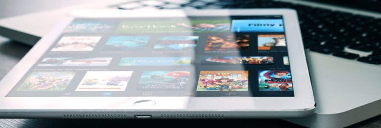 High-quality tablet displaying digital content and entertainment, tech devices setup, modern electronic gadgets for media consumption, close-up of portable entertainment technology.