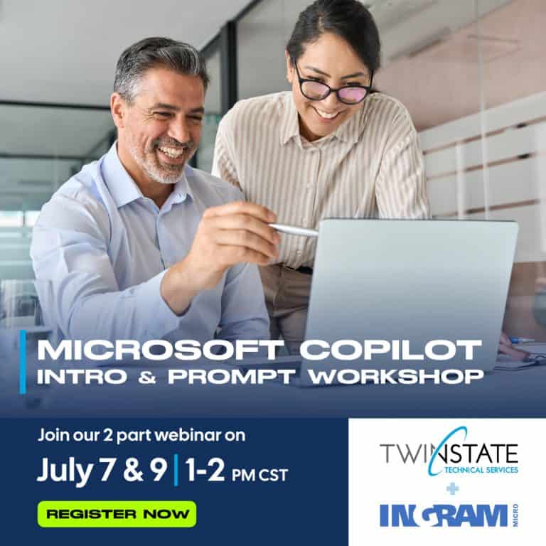 Two professionals collaborating on a laptop during the Microsoft Copilot webinar, focusing on tech training in the Quad Cities area.